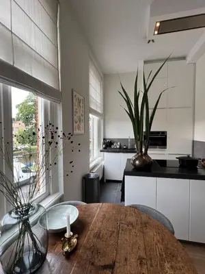 a kitchen with a wooden table in a room at Modern & Luxurious stay Haarlem in Haarlem