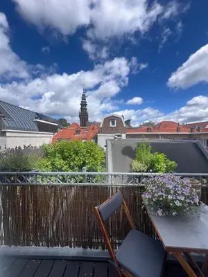 a balcony with a table and a view of the city at Modern & Luxurious stay Haarlem in Haarlem
