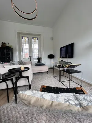 a living room with a couch and a tv at Modern & Luxurious stay Haarlem in Haarlem
