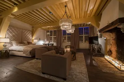 a bedroom with a bed and a fireplace at Boutique Hotel Steenhof Suites - Adults Only in Leiden