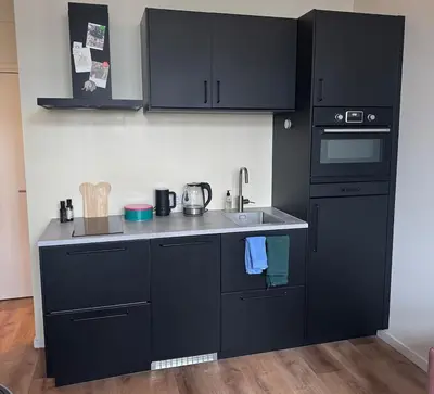 a kitchen with black cabinets and a sink at studio at the Rijksmuseum in Amsterdam