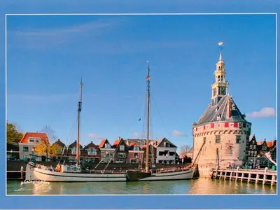 two boats in the water next to a lighthouse at Apartment Haus Jule by Interhome in Wervershoof