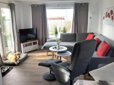 a living room with a dog laying on a couch at Apartment Chalet Meise by Interhome in Wervershoof