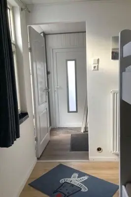 a hallway with a door and a rug on the floor at Apartment Chalet Meise by Interhome in Wervershoof