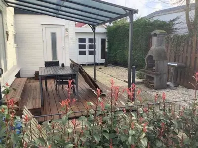 a backyard with a wooden deck with a grill at Apartment Chalet Meise by Interhome in Wervershoof