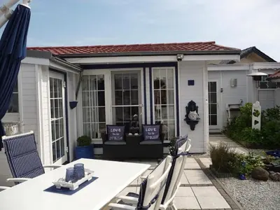 a patio with a table and chairs in front of a house at Holiday Home De Graaf by Interhome in Wervershoof