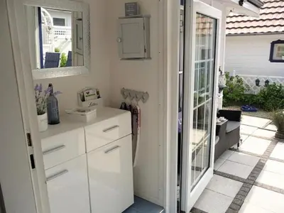 a kitchen with white cabinets and a mirror at Holiday Home De Graaf by Interhome in Wervershoof