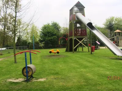 a playground with a slide in a park at Holiday Home De Graaf by Interhome in Wervershoof