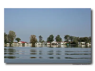 a large body of water with houses in the background at Holiday Home De Graaf by Interhome in Wervershoof