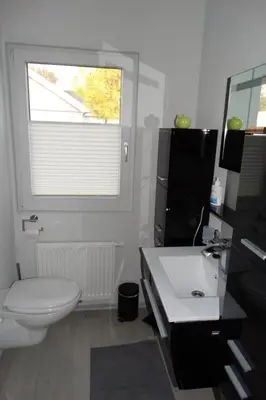 a bathroom with a white toilet and a window at Holiday Home Schönes Ferienhaus in Wervershoof mit Garten- Grill und Terrasse by Interhome in Wervershoof