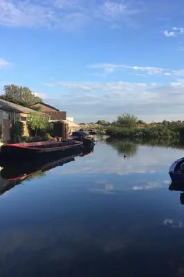 a group of boats docked on a river at Holiday Home Schönes Ferienhaus in Wervershoof mit Garten- Grill und Terrasse by Interhome in Wervershoof