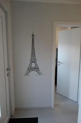 a drawing of the eiffel tower on a wall at Holiday Home Schönes Ferienhaus in Wervershoof mit Garten- Grill und Terrasse by Interhome in Wervershoof