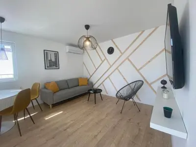 a living room with a couch and a table and chairs at Holiday Home Sonnenschein by Interhome in Wervershoof
