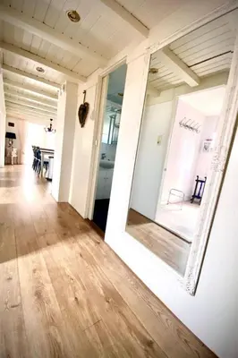 a room with a large mirror on the wall at Holiday Home Charmantes Ferienhaus Hilda mit Terrasse by Interhome in Wervershoof
