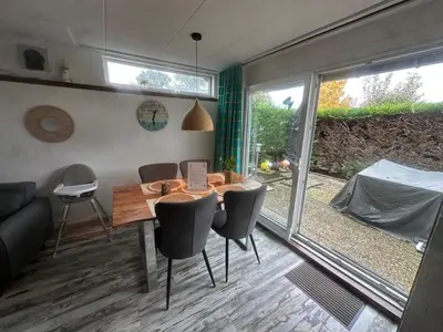 a room with a table and chairs and a large window at Holiday Home by Interhome in Wervershoof