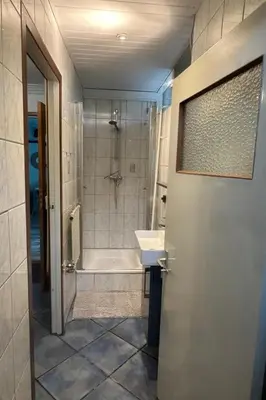 a bathroom with a tub and a sink and a shower at Holiday Home by Interhome in Wervershoof