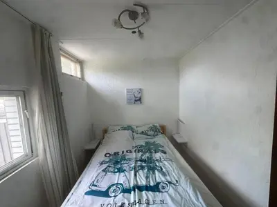 a small bedroom with a bed in a room at Holiday Home by Interhome in Wervershoof