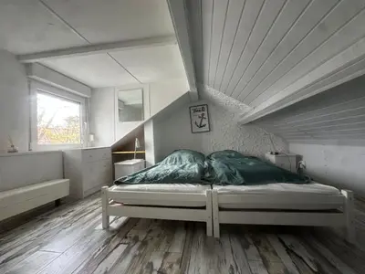 a bedroom with a bed with green pillows on it at Holiday Home by Interhome in Wervershoof
