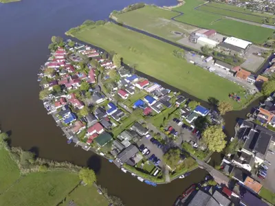 an aerial view of a group of houses next to the water at Holiday Home Haus Jeff by Interhome in Wervershoof