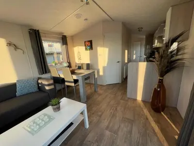 a living room with a couch and a table at Holiday Home Haus Jeff by Interhome in Wervershoof