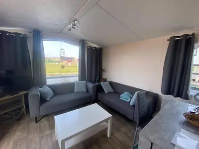 a living room with a couch and a table at Holiday Home Haus Jeff by Interhome in Wervershoof