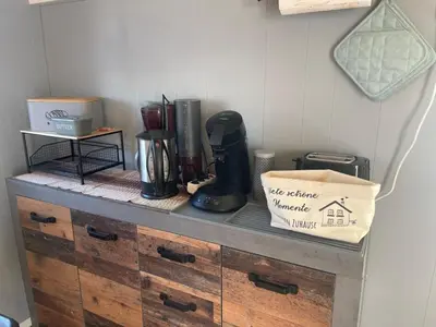 a counter with a coffee maker and a bag on it at Apartment Haus Moony by Interhome in Wervershoof