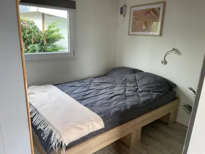 a small bed in a room with a window at Apartment Haus Moony by Interhome in Wervershoof