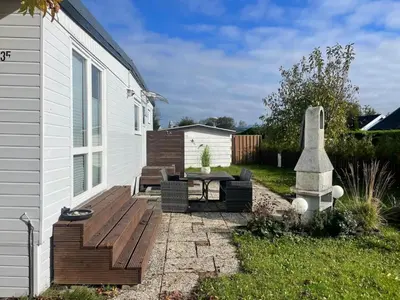 a patio with a table and a bench next to a house at Apartment Haus Moony by Interhome in Wervershoof