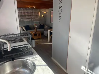 a kitchen with a sink and a living room at Apartment Haus Moony by Interhome in Wervershoof