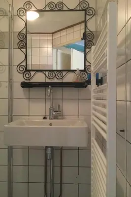 a bathroom with a sink and a mirror at Holiday Home in Dirkshorn by Interhome in Dirkshorn