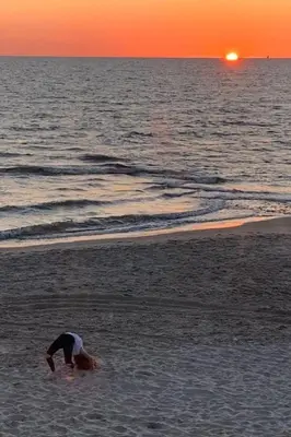 a person standing in the water at the beach at Holiday Home in Dirkshorn by Interhome in Dirkshorn