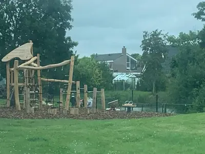 a wooden playground in a park with at Holiday Home in Dirkshorn by Interhome in Dirkshorn