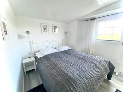 a bedroom with a bed and a window at Holiday Home Isabella by Interhome in Wervershoof