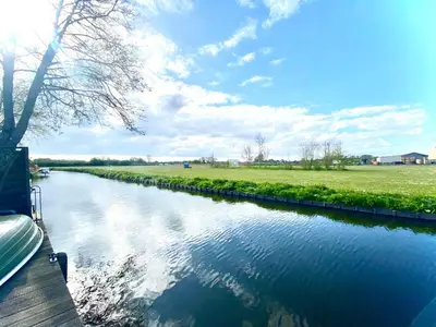 a view of a river with a boat on it at Holiday Home Isabella by Interhome in Wervershoof