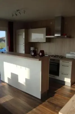 a kitchen with a stove and a counter top at Holiday Home Auszeit direkt am Wasser by Interhome in Wervershoof