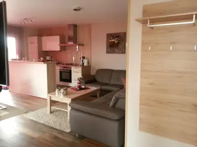a living room with a couch and a table at Holiday Home Auszeit direkt am Wasser by Interhome in Wervershoof