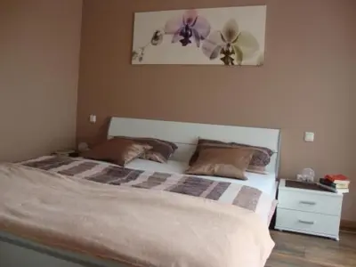 a bedroom with a bed with two pillows at Holiday Home Auszeit direkt am Wasser by Interhome in Wervershoof