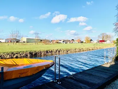 a boat is docked next to a dock at Holiday Home Balu by Interhome in Wervershoof
