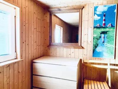 a sauna with a bench and a window and a lighthouse at Holiday Home Balu by Interhome in Wervershoof