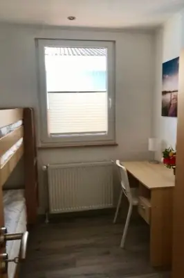 a bedroom with a desk and a window with a window blind at Holiday Home Haus DE BLAUWE REIGER by Interhome in Wervershoof