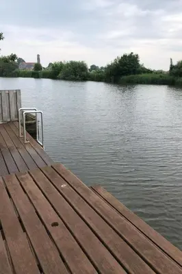 a wooden dock on a body of water at Apartment Tami by Interhome in Wervershoof