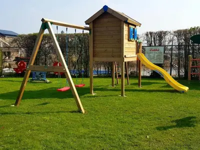 a playground with a slide and a play structure at Holiday Home in Wervershoof mit Sonniger Terrasse by Interhome in Wervershoof