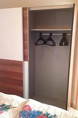 a bedroom with a closet with black shelves at Holiday Home in Wervershoof mit Sonniger Terrasse by Interhome in Wervershoof