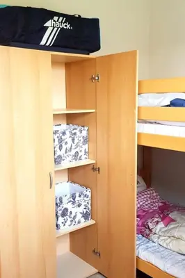 a bunk bed in a dorm room with boxes at Holiday Home in Wervershoof mit Sonniger Terrasse by Interhome in Wervershoof