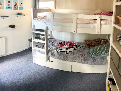 a bunk bed room with two bunk beds at Holiday Home direkt am See by Interhome in Wervershoof