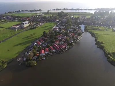 an aerial view of a river with a group of houses at Holiday Home Haus Good Times by Interhome in Wervershoof