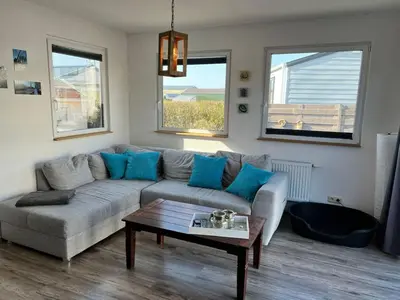 a living room with a couch and a coffee table at Holiday Home Haus Good Times by Interhome in Wervershoof