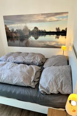 two beds in a room with a painting on the wall at Holiday Home Haus Good Times by Interhome in Wervershoof