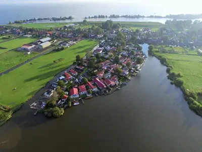 an aerial view of a group of houses and a river at Apartment Familienfreundliches Ferienhaus Angel mit Garten by Interhome in Wervershoof