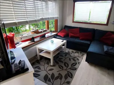 a living room with a blue couch and a table at Apartment Het kleine Hemeltje by Interhome in Wervershoof